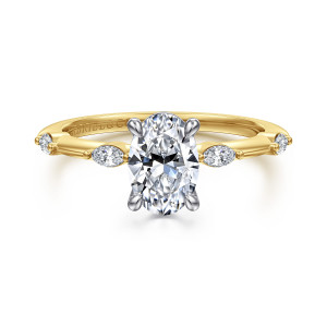 Gabriel & Co. ER16432O4M43JJ 14 karat white and yellow gold Starlight engagement ring, front view of an oval center in a contrasting head with elongated diamonds spaced along the band