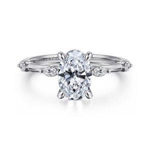 Gabriel & Co. ER16432O6W43JJ 14 karat white gold Starlight engagement ring, front view of an oval center with elongated diamonds set lengthwise on a slim band