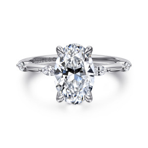 Gabriel & Co. ER16432O8W43JJ 14 karat white gold Starlight engagement ring, front view of a tall oval center between elongated diamonds set apart along the thin shoulders
