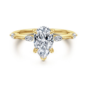 Gabriel & Co. ER16432P6Y43JJ 14 karat yellow gold Starlight engagement ring, front view of the pear shaped center with a pointed tip and elongated stones on both shoulders