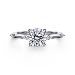 Gabriel & Co. ER16432R4W43JJ 14 karat white gold Starlight engagement ring, front view of a round center in four prongs between elongated stones set along each shoulder