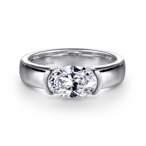 Gabriel & Co. ER16433O6W4JJJ 14 karat white gold Contemporary engagement ring, front view of an oval center turned across the finger between curved end bars