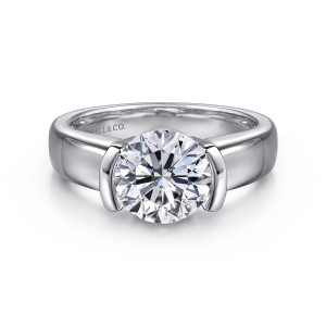 Gabriel & Co. ER16433R6W4JJJ 14 karat white gold Contemporary engagement ring, front view of a round center clasped between two curved walls on a broad polished band