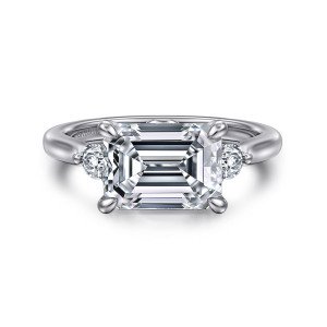 Gabriel & Co. ER16435E12W44JJ 14 karat white gold Lotus engagement ring, front view of an east to west emerald cut center with a small round stone on each side