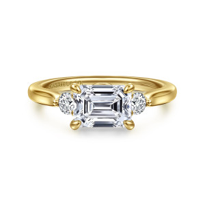 Gabriel & Co. ER16435E6Y44JJ 14 karat yellow gold Lotus engagement ring, front view of a sideways emerald cut center flanked by a small round diamond on each end