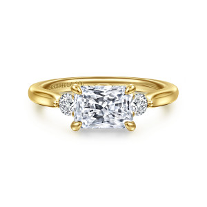 Gabriel & Co. ER16435N6Y44JJ 14 karat yellow gold Lotus engagement ring, front view of a sideways radiant cut center flanked by round diamonds on a tapering band