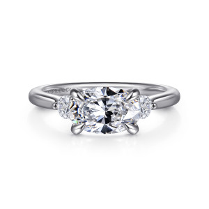 Gabriel & Co. ER16435O6W44JJ 14 karat white gold Lotus engagement ring, front view of an oval center set sideways between two round stones, held by four prongs