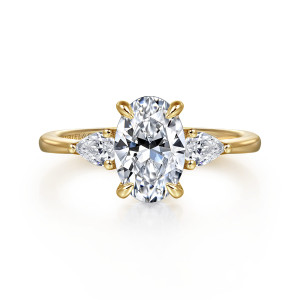 Gabriel & Co. ER16437O6Y44JJ 14 karat yellow gold Classic engagement ring, front view of an oval center between pear shaped side stones with tiny beads at their tips