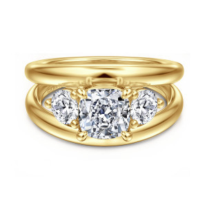 Gabriel & Co. ER16444C6Y44JJ 14 karat yellow gold Contemporary engagement ring, front view of a cushion cut center between two round side diamonds above a wide smooth split band