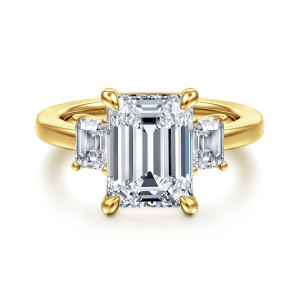 Gabriel & Co. ER16463E16Y43JJ 14 karat yellow gold Classic engagement ring, front view of the emerald cut center in corner prongs with a step cut stone each side