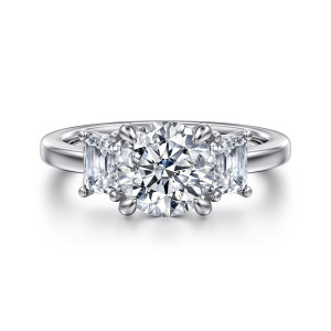 Gabriel & Co. ER16463R6W43JJ 14 karat white gold Classic engagement ring, front view of a round center pressed between two step cut diamonds with small corner prongs