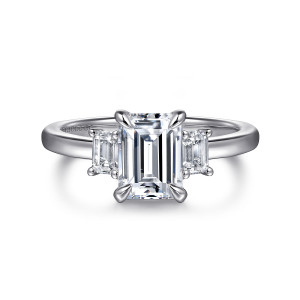 Gabriel & Co. ER16464E6W43JJ 14 karat white gold Classic engagement ring, front view of an emerald cut center between two step cut side stones on a plain band
