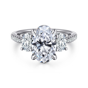 Gabriel & Co. ER16467O10W44JJ 14 karat white gold Classic engagement ring, front view of an oval center between two oval side stones on a stone set band
