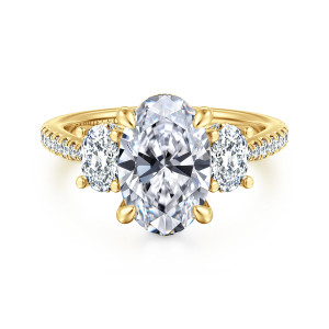 Gabriel & Co. ER16467O10Y44JJ 14 karat yellow gold Classic engagement ring, front view of an oval center with teardrop tipped prongs and an oval side stone on each side