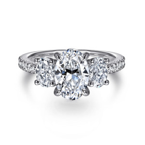Gabriel & Co. ER16467O6W44JJ 14 karat white gold Classic engagement ring, front view of an oval center between two oval side stones with round stones along the band