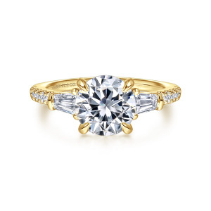 Gabriel & Co. ER16471R6Y44JJ 14 karat yellow gold Contemporary engagement ring, front view of a round center between tapered baguettes, with small diamonds along both shoulders