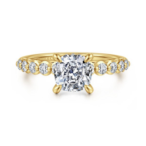 Gabriel & Co. ER16472C6Y44JJ 14 karat yellow gold Contemporary engagement ring, front view of a cushion cut center with teardrop shaped prongs and beaded round diamonds on the shoulders