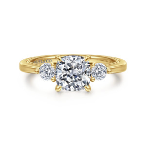 Gabriel & Co. ER16475C6Y44JJ 14 karat yellow gold Classic engagement ring, front view of a cushion center with a round side stone on each side and milgrain inside