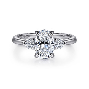 Gabriel & Co. ER16475O6W44JJ 14 karat white gold Classic engagement ring, front view of an oval center in four claws flanked by round stones in small prongs