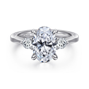 Gabriel & Co. ER16475O8W44JJ 14 karat white gold Classic engagement ring, front view of an oval center with round side stones and four rounded tapered prongs
