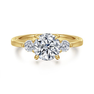 Gabriel & Co. ER16475R6Y44JJ 14 karat yellow gold Classic engagement ring, front view of a round center held by four pointed prongs beside two ball tipped side stones