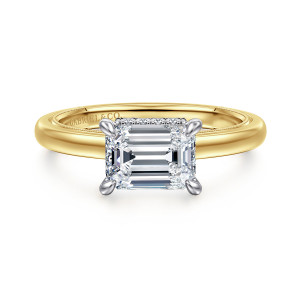 Gabriel & Co. ER16476E6M44JJ 14 karat white and yellow gold Classic engagement ring, front view of an emerald cut center set sideways with a milgrain edge along the band