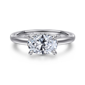 Gabriel & Co. ER16476O6W44JJ 14 karat white gold Classic engagement ring, front view of an oval center set sideways in four claws with milgrain edging inside the band