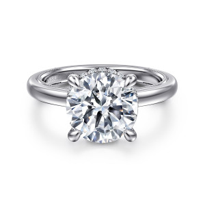 Gabriel & Co. ER16476R12W44JJ 14 karat white gold Classic engagement ring, front view of a round center on rounded claw prongs with diamonds just showing beneath it