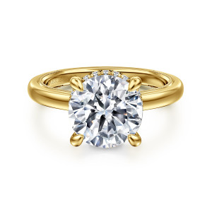 Gabriel & Co. ER16476R12Y44JJ 14 karat yellow gold Classic engagement ring, front view of a round center in teardrop tipped prongs with diamonds showing behind the stone