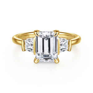 Gabriel & Co. ER16477E8Y44JJ 14 karat yellow gold Classic engagement ring, front view of an emerald cut center with four rounded claws beside tapered side stones in flat bars