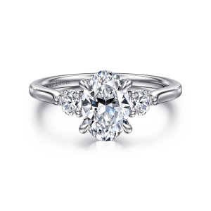 Gabriel & Co. ER16484O6W44JJ 14 karat white gold Lotus engagement ring, front view of an oval center between two round side stones with a maker's mark inside the band