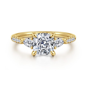 Gabriel & Co. ER16486C6Y44JJ 14 karat yellow gold Lotus engagement ring, front view of a cushion cut center with leaf shaped prongs between two pear shaped stones