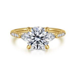 Gabriel & Co. ER16486R8Y44JJ 14 karat yellow gold Lotus engagement ring, front view of the round center between two larger side stones and diamond lined shoulders