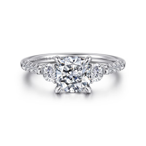 Gabriel & Co. ER16487C6W44JJ 14 karat white gold Lotus engagement ring, front view of a cushion center between round side stones with small diamonds on the shoulders