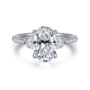 Gabriel & Co. ER16487O8W44JJ 14 karat white gold Lotus engagement ring, front view of an oval center with round side diamonds and small diamonds along the shoulders