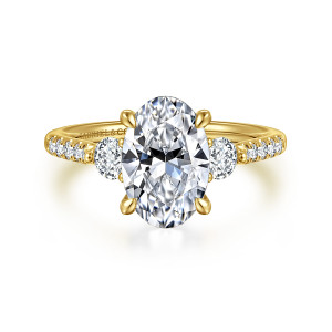 Gabriel & Co. ER16487O8Y44JJ 14 karat yellow gold Lotus engagement ring, front view of an oval center between two round side stones with stone lined shoulders
