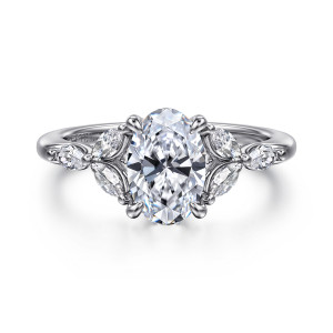 Gabriel & Co. ER16495O6W43JJ 14 karat white gold Floral Nouveau engagement ring, front view of an oval center flanked by leaf shaped clusters of small elongated diamonds