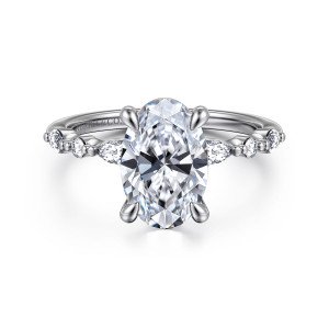 Gabriel & Co. ER16497O8W44JJ 14 karat white gold Contemporary engagement ring, front view of an oval center with elongated and round diamonds set on the shoulders between beads