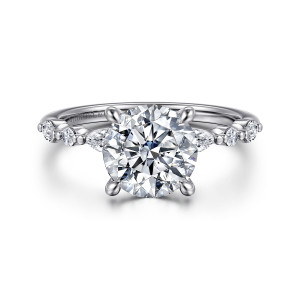 Gabriel & Co. ER16497R8W44JJ 14 karat white gold Contemporary engagement ring, front view of a round center with small round and elongated stones spaced by beads