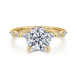Gabriel & Co. ER16497R8Y44JJ 14 karat yellow gold Contemporary engagement ring, front view of a round center flanked by elongated diamonds and round stones divided by beads