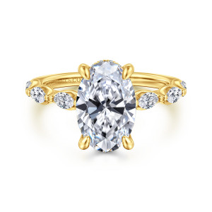 Gabriel & Co. ER16498O10Y44JJ 14 karat yellow gold Contemporary engagement ring, front view of an oval center in four rounded prongs with framed elongated stones on the shoulders