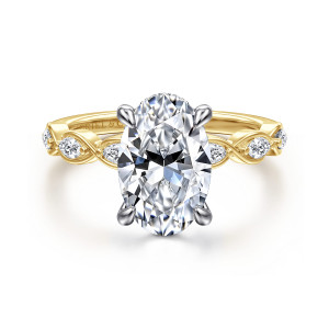 Gabriel & Co. ER16505O10M44JJ 14 karat white and yellow gold Contemporary engagement ring, front view of an oval center with four claws and elongated diamonds framed by crossing ribbon loops