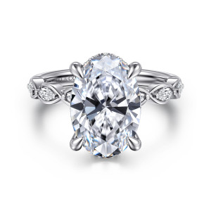 Gabriel & Co. ER16505O16W44JJ 14 karat white gold Contemporary engagement ring, front view of the oval center with teardrop prongs and looped ribbon shoulders framing elongated stones