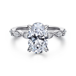 Gabriel & Co. ER16505O8W44JJ 14 karat white gold Contemporary engagement ring, front view of an oval center above shoulders of twisting loops that each hold an elongated stone