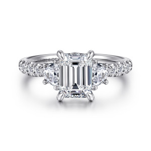 Gabriel & Co. ER16507E6W44JJ 14 karat white gold Lotus engagement ring, front view of an emerald cut center between half moon diamonds with round stones on the shoulders