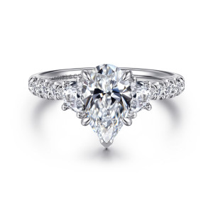 Gabriel & Co. ER16507P6W44JJ 14 karat white gold Lotus engagement ring, front view of a pear shaped center with a V tip prong between flat sided half moon stones