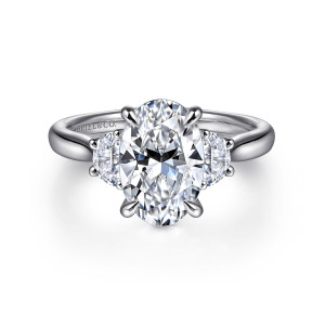 Gabriel & Co. ER16508O8W43JJ 14 karat white gold Lotus engagement ring, front view of an oval center held by claw prongs between two half moon stones