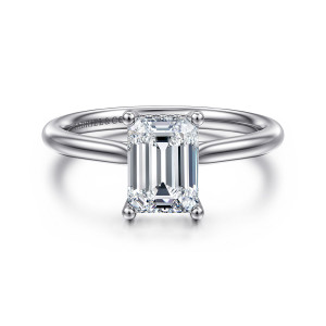 Gabriel & Co. ER16512E6PT4JJ platinum Classic engagement ring, front view of an emerald cut center held by four rounded prongs on a smooth band