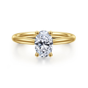 Gabriel & Co. ER16512O4Y44JJ 14 karat yellow gold Classic engagement ring, front view of an oval center held by four bead tipped prongs over a smooth rounded band
