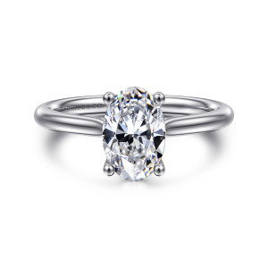 Gabriel & Co. ER16512O6W84JJ 18 karat white gold Classic engagement ring, front view of the oval center held by four ball tipped prongs on a smooth tapering band